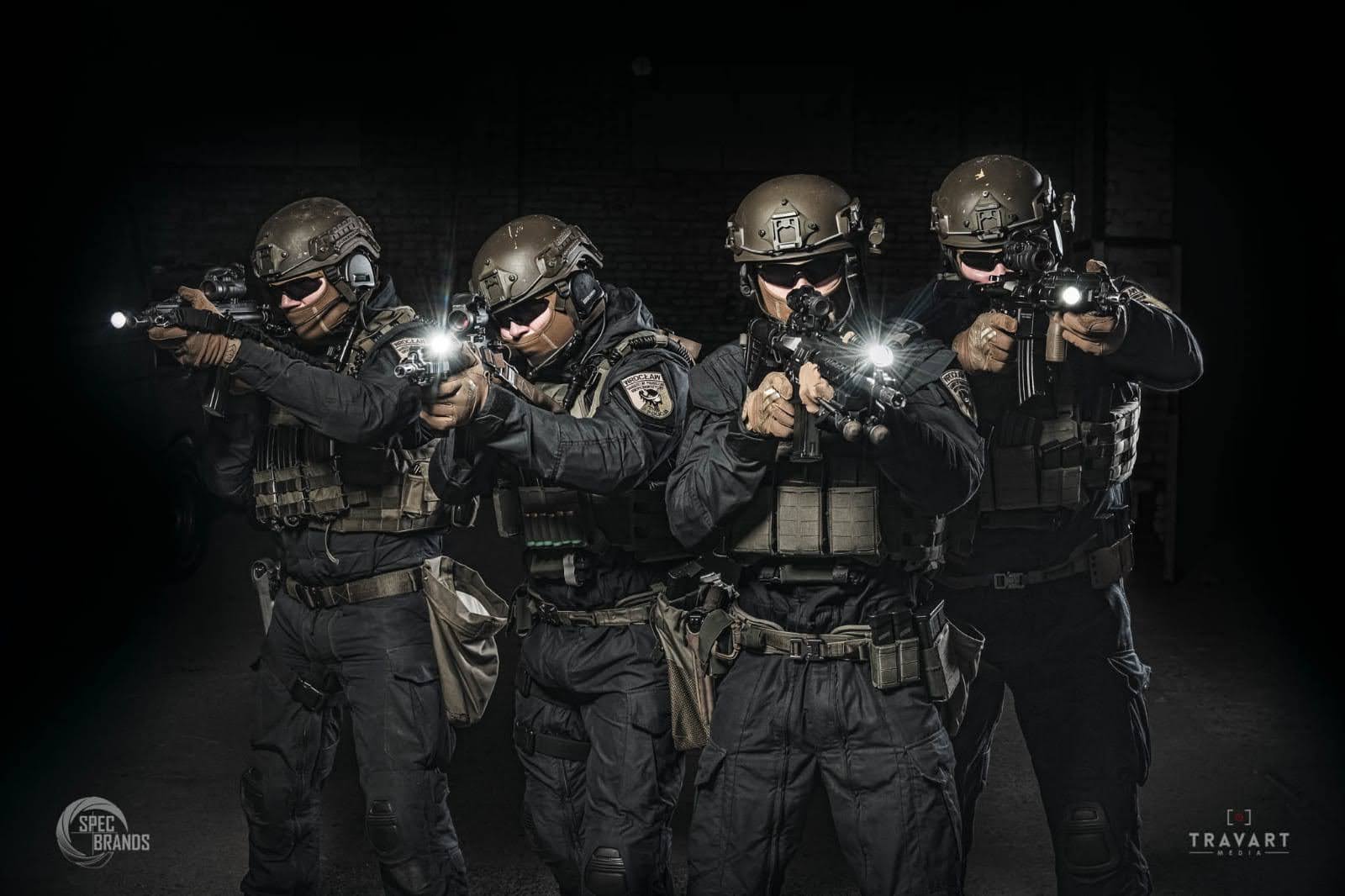 Four armed special forces soldiers in tactical gear during an operational mission